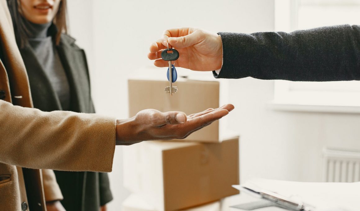 person giving keys from new home to family