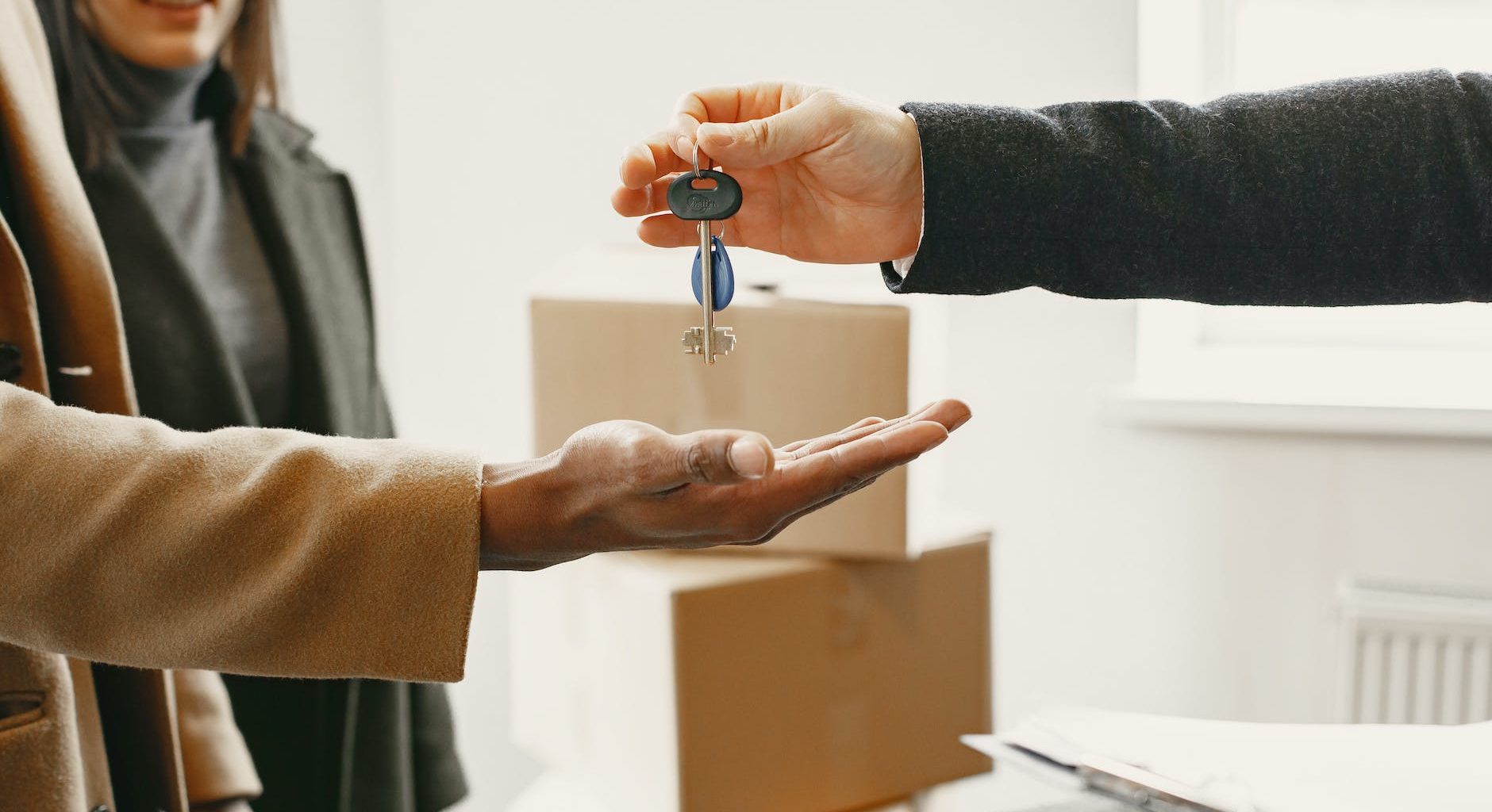 person giving keys from new home to family