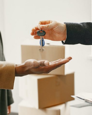 person giving keys from new home to family