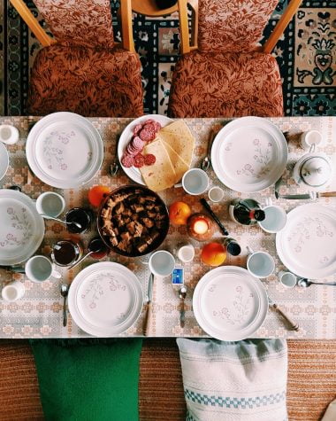 high angle photography of dinner set on table surrounded with padded chairs